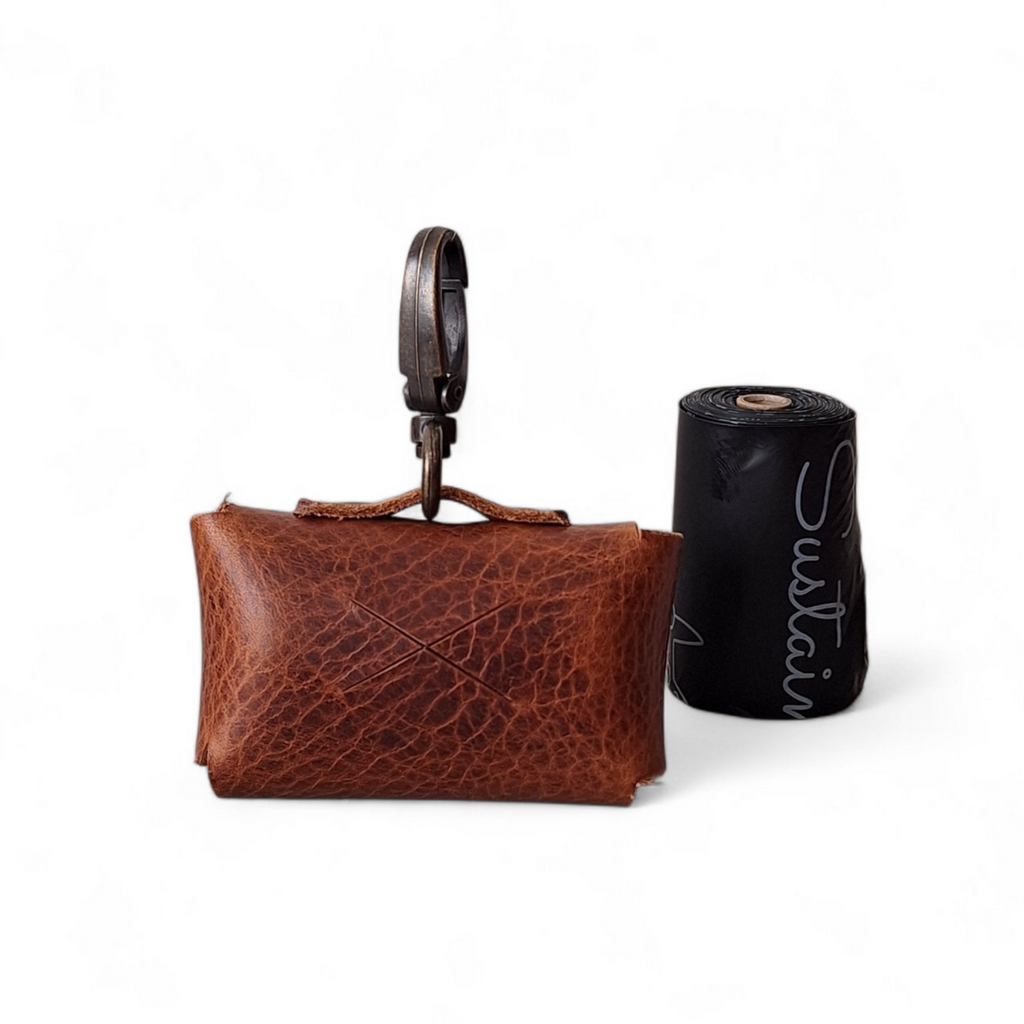 Smart-dispense feature on a handcrafted brown leather dog bag pouch.