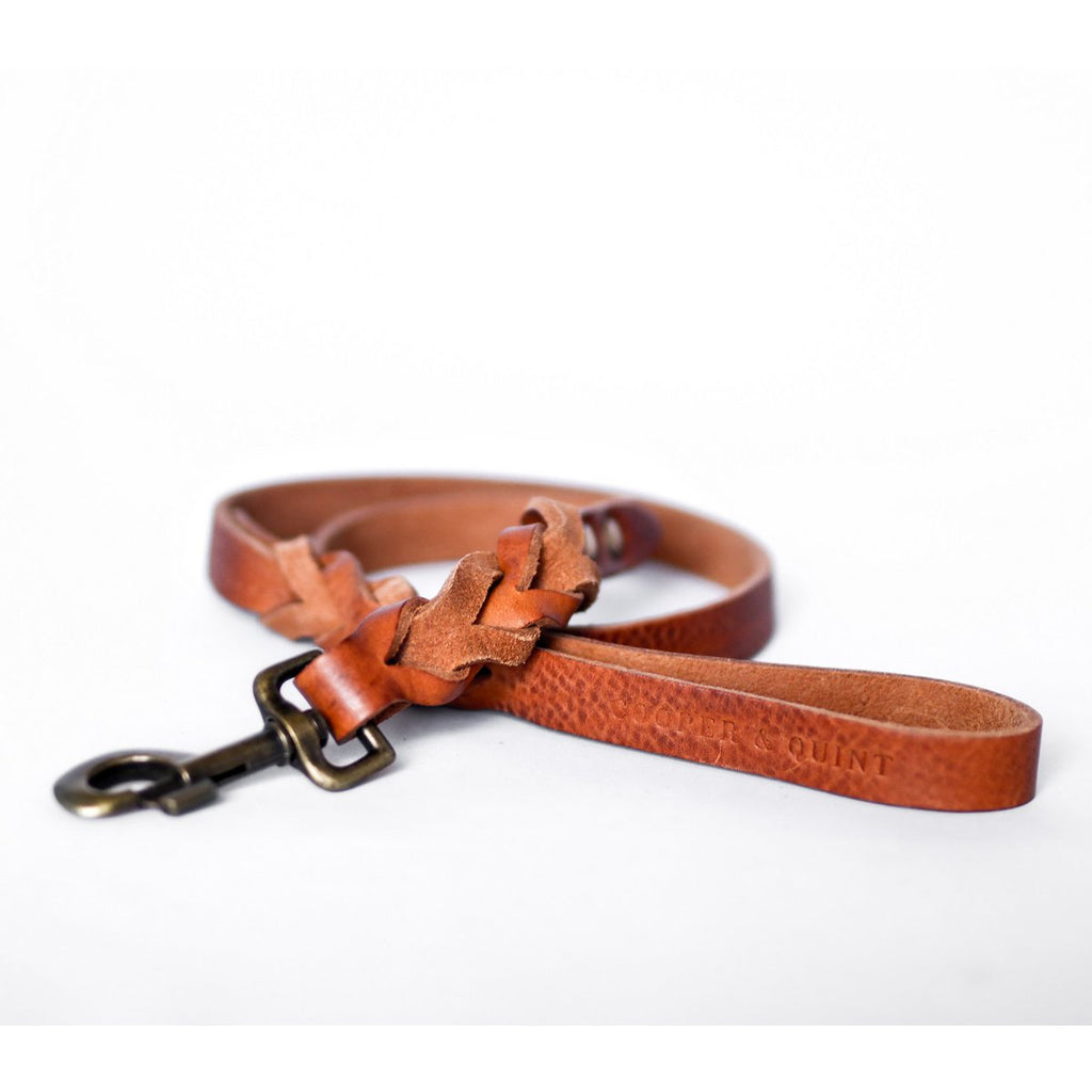 Close-up of hand-braided camel cognac leather dog leash showing artisanal twisted detail.