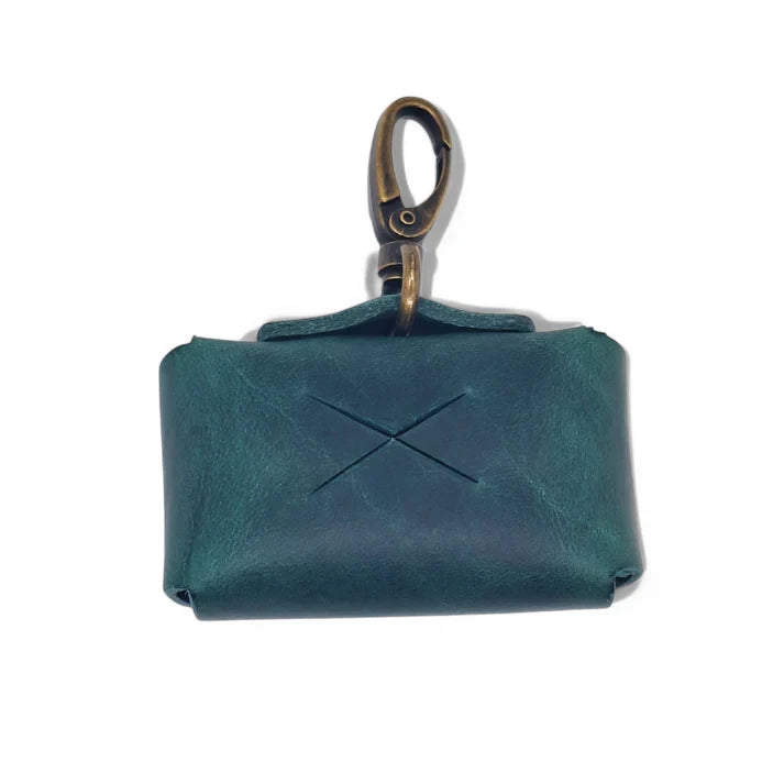 Premium forest green leather dog waste bag holder with antique brass hardware.
