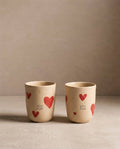 Pair of 220 ml Cozy Hearts stoneware cups with red heart motifs, side view
