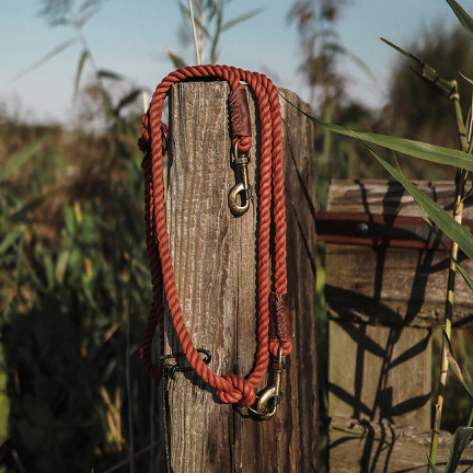Close-up of durable 10mm rusty red cotton rope showing the three-strand twist