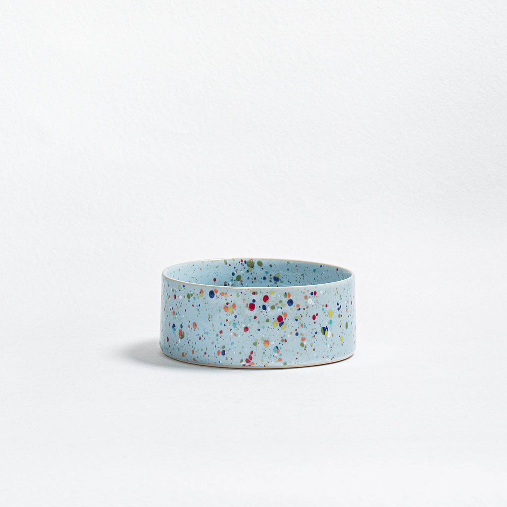 Close-up of a single New Party pet bowl showing the unique handcrafted blue speckled ceramic texture.
