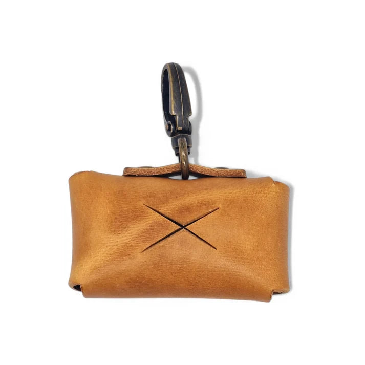 Warm camel cognac leather dog waste bag holder with vintage brass clip.