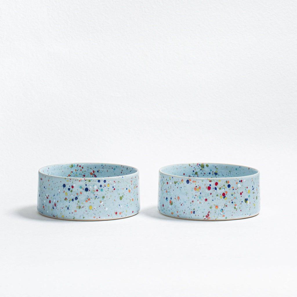 A matching set of two Soft Blue New Party pet bowls in handcrafted speckled stoneware.