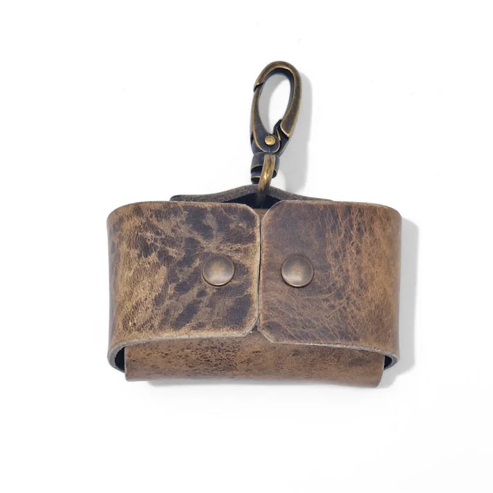Minimalist stone grey leather dog waste bag holder with antique brass hardware.