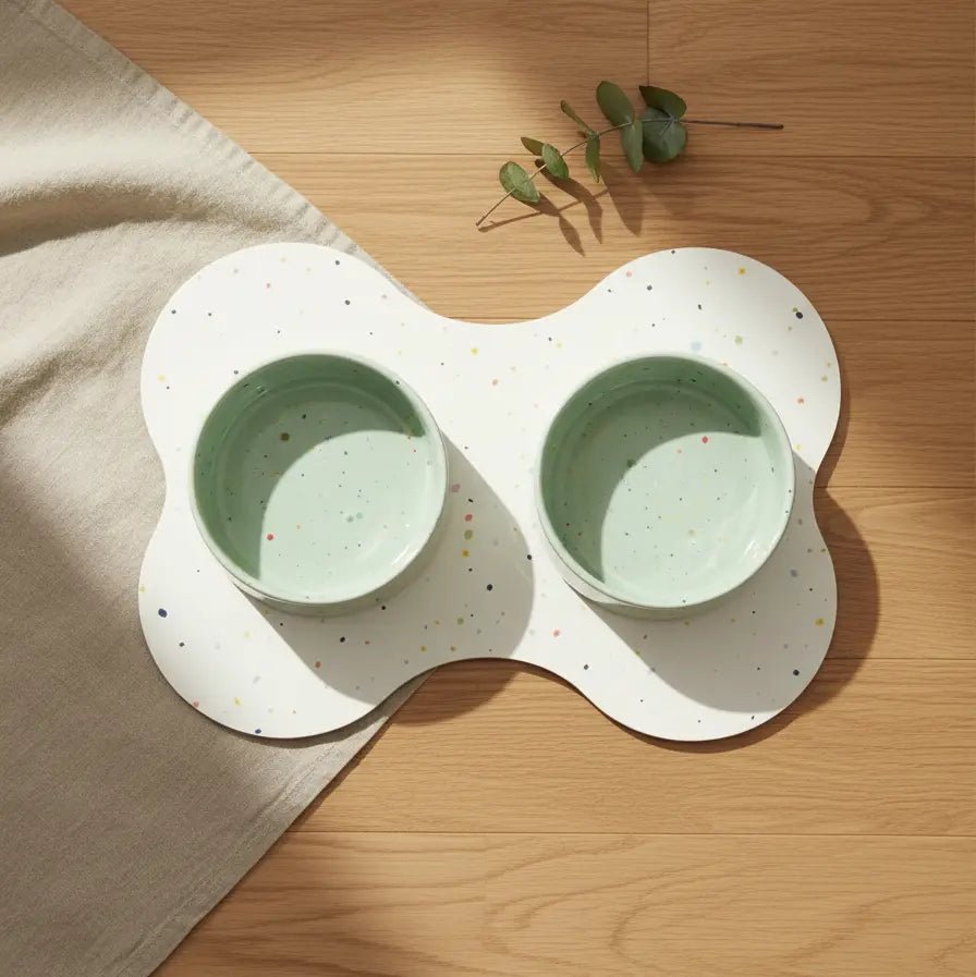 Sage Green Splatter 16.5 cm bowls on a bone-shaped placemat