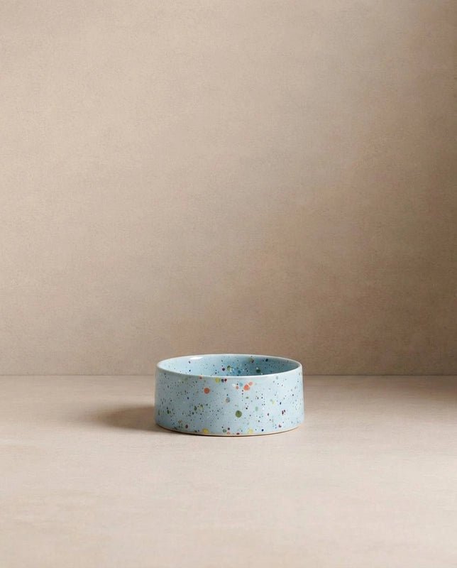 Single Soft Blue Splatter stoneware bowl on a beige backdrop
