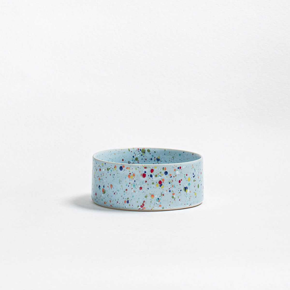 Soft Blue Splatter stoneware dog bowl on a white background